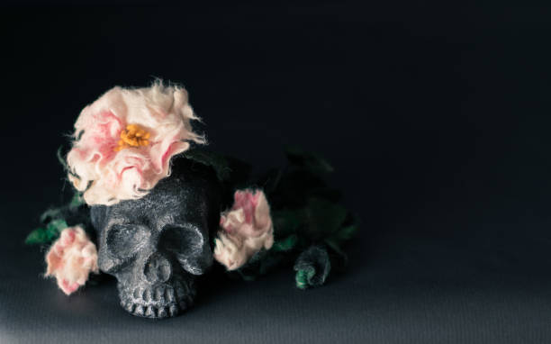 istock Black skull with flowers and leaves. 861030678