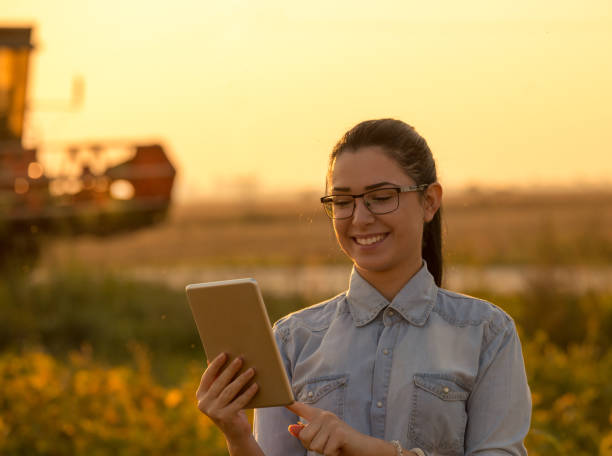 istock Agronomist with tablet in front of combine harvester 861030764