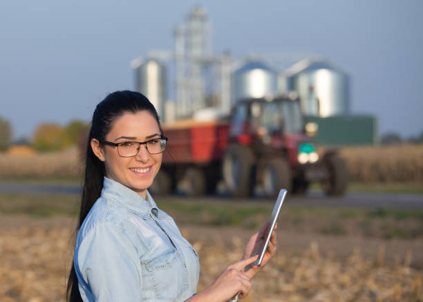 istock Agronomist with tablet and silos in background 861030836
