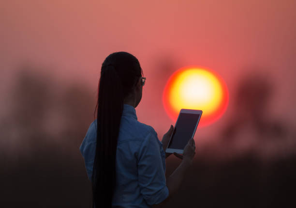 istock Woman with tablet at sunset 861031012