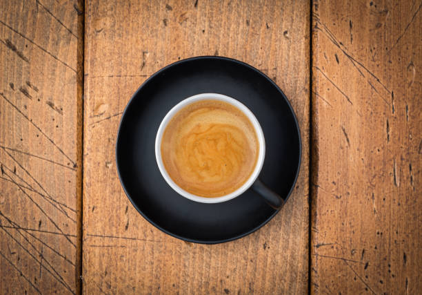 istock Black cup of coffee on rustic table from top view. 861037224