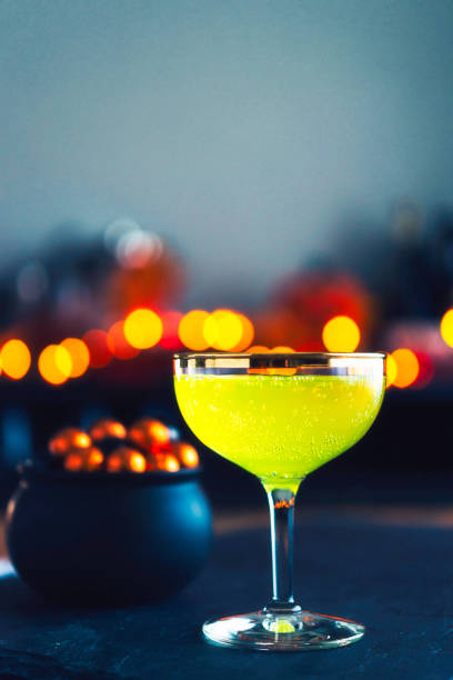 istock Halloween time. Lime green drink with cauldron of candy 861037614