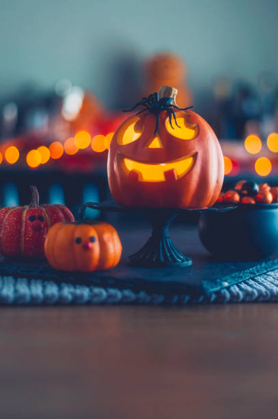 istock Halloween time. Jack O'Lanterns with cauldron of candy 861039830
