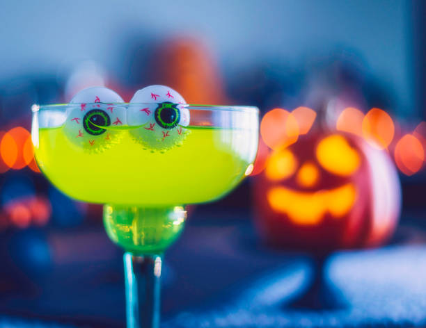 istock Halloween time. Lime green drink with eyeballs and Jack O'Lantern decorations 861039910