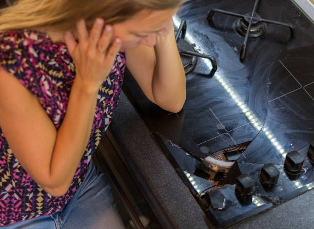 istock View above woman looking broken cooker plate 861040154
