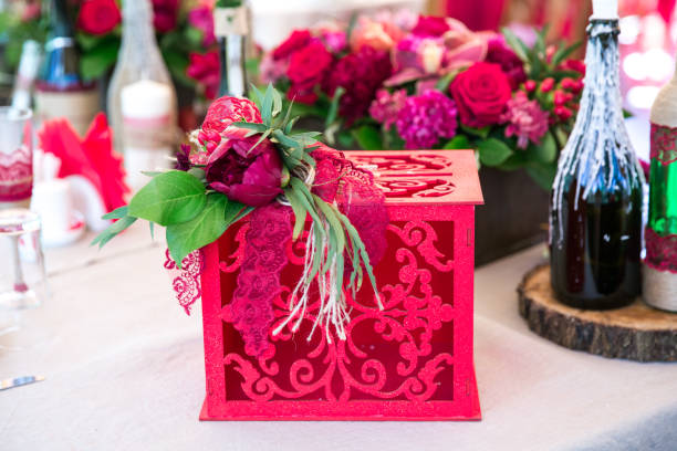 istock Gift box with flowers on red background 861047060