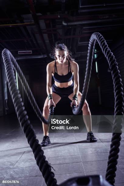 Battle Ropes Session Attractive Young Fit Sportswoman Working Out In Training Gym Stock Photo - Download Image Now