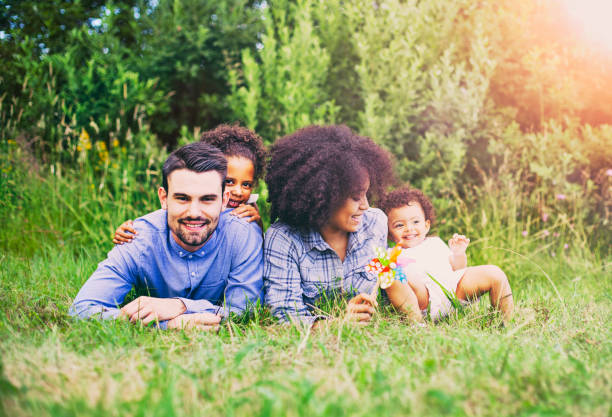 istock Happy family lying down on grass in park. 861053778