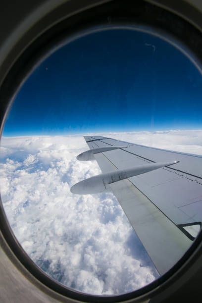 istock View from airplane window with blue sky and white clouds 861053800