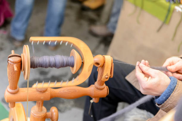 istock Master spinner spins yarn from wool on an old spinning loom. 861054000