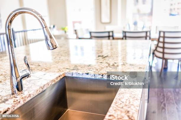 New Modern Faucet And Kitchen Room Sink Closeup With Island And Granite Countertops In Model House Home Apartment Stock Photo - Download Image Now