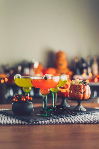 istock Halloween time. Vibrant colored drinks with cauldron of candy 861066704