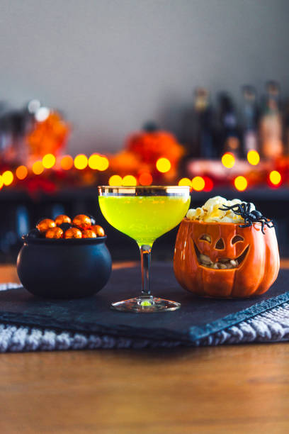 istock Halloween time. Lime green drink with cauldron of candy 861066710