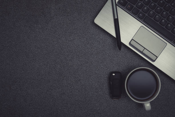istock Laptop computer or notebook and a cup of coffee  on gray color modern working table or desk with copy space top view. 861072234