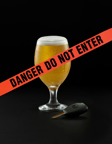 “danger do not enter” sign in front of a glass of beer