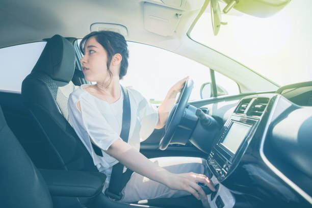 istock young woman driver turning back. 861086760