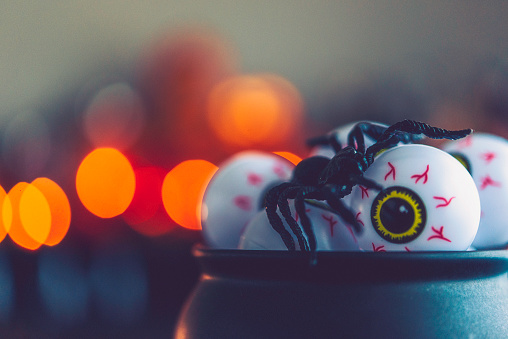 Halloween time. Cauldron filled with eyeballs and spiders
