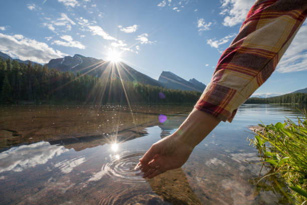 istock Human hand cupped to catch fresh water from mountain lake 861089986
