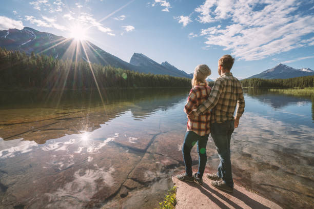 istock Young couple being affectionate by the lake at sunrise 861092414