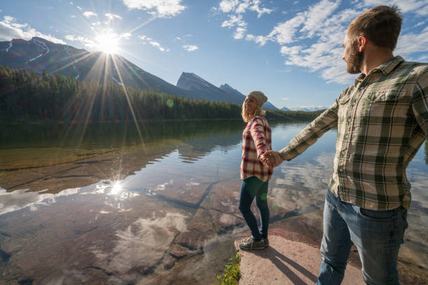 istock Young couple being affectionate by the lake at sunrise 861092738