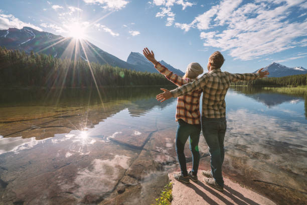 istock Young couple relaxing by the lake at sunrise 861092748