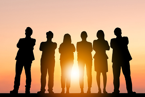 Silhouette of Business People Celebration Success Happiness Team standing with arms crossed at Sunset Evening Sky Background