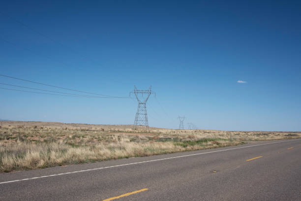 istock HIGH VOLTAGE POWER TOWERS IN FIELD WITH BLUE SKY, USA 861107816