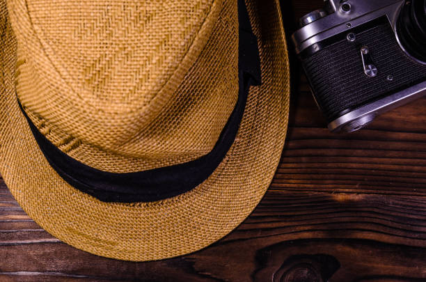 istock Old rangefinder camera and hat on a wooden table. Top view 861111274
