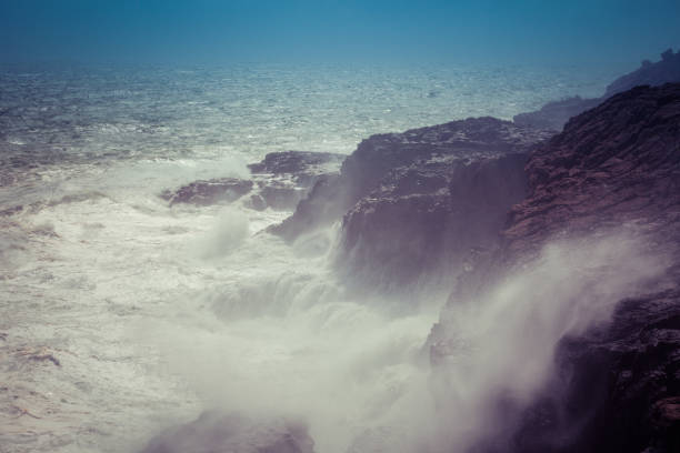 Waves breaking hard on rocks - extreme force of nature