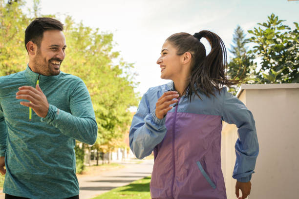 istock Two young friends running together on sidewalk. 861117804