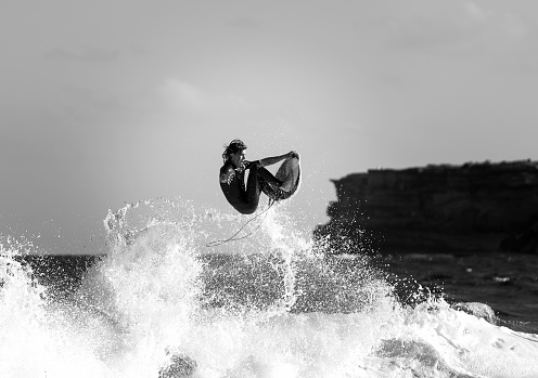 Sydney, Australia - January 21, 2017. Black and white photo of a surfer at Tamarama beach.