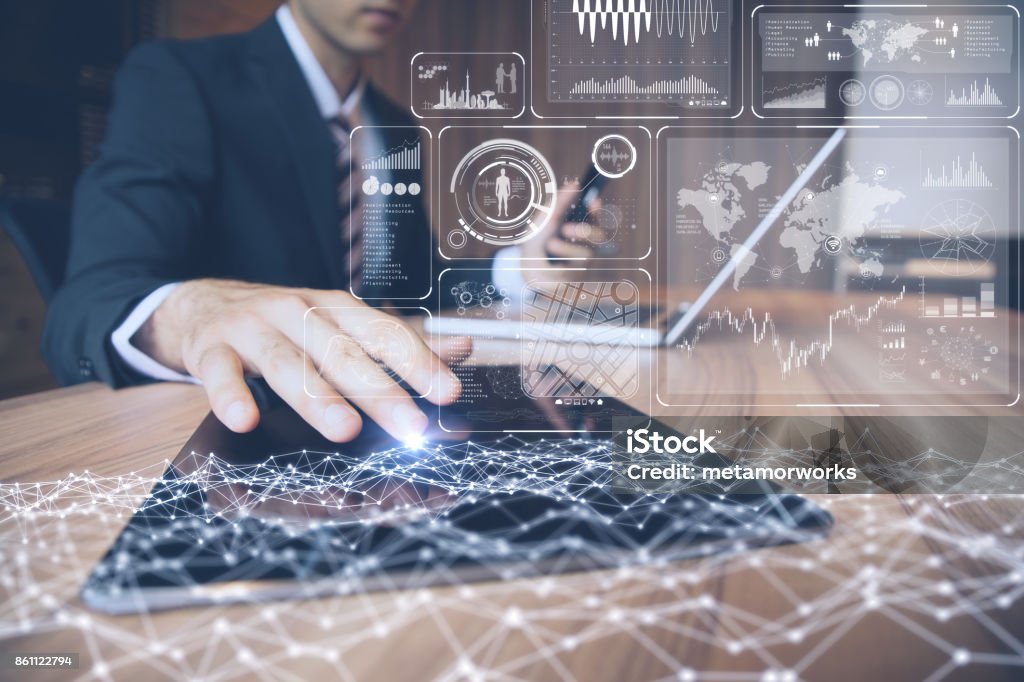businessman using tablet PC and information communication technology concept. IoT(Internet of Things). GUI(graphical user interface). paperless office. Business Stock Photo