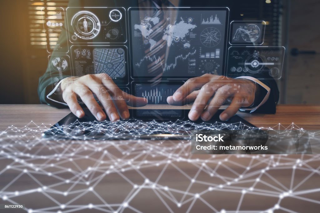 businessman using tablet PC and information communication technology concept. IoT(Internet of Things). GUI(graphical user interface). paperless office. Automated Stock Photo
