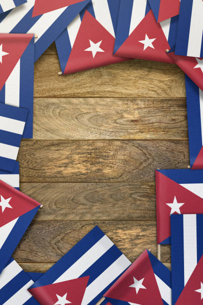 istock Cuba small flags framing a wood texture background with copy space 861122946