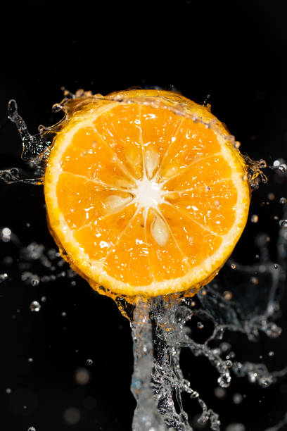 istock orange in water on a black background 861126446