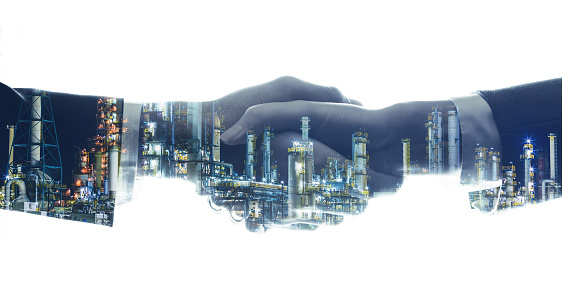 business and industry concept. businessperson shaking hands and modern factory image. mixed media.
