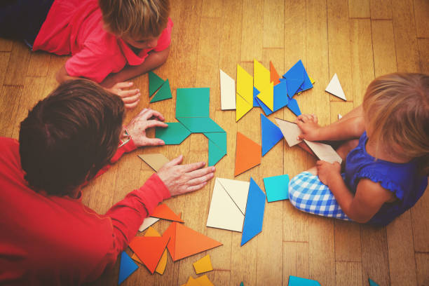 istock teacher and kids playing with geometric shapes 861133420