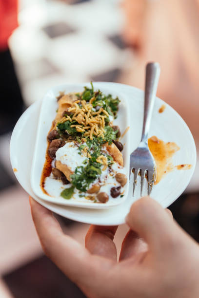 istock Papri Chaat is traditionally prepared using crisp fried dough wafers known as papri, along with boiled chick peas, boiled potatoes, yogurt and tamarind chutney and topped with chaat masala and sev. 861134020