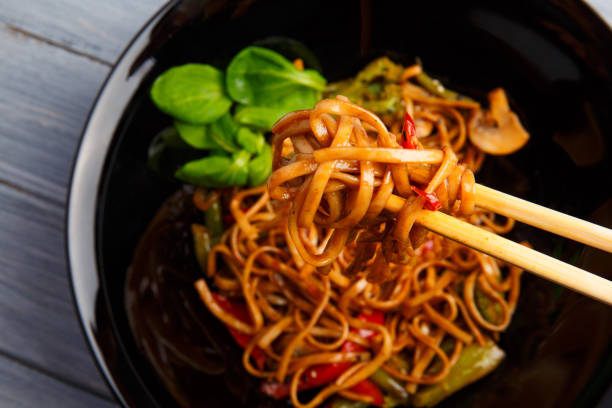 istock Traditional Chinese dish on a round plate, rice noodles, cabbage green cabbage and fried vegetables. 861139290