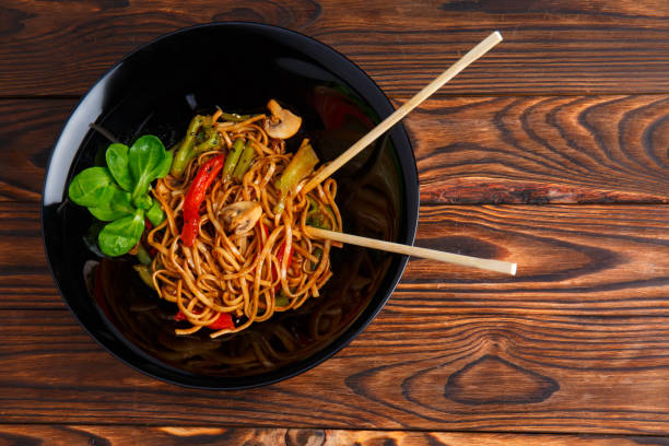 istock Traditional Chinese dish on a round plate, rice noodles, cabbage or green cabbage and fried vegetables. 861139400