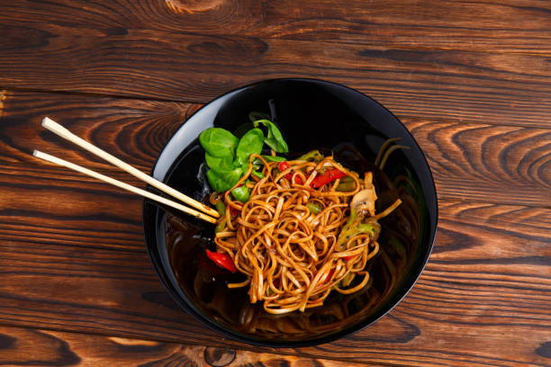 istock Traditional Chinese dish on a round plate, rice noodles, cabbage green cabbage and fried vegetables. 861139938