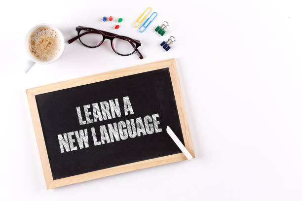 istock LEARN A NEW LANGUAGE word on Chalkboard with Coffee Cup, view from above 861142896