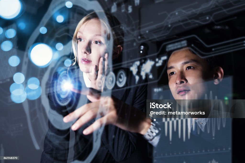 Two persons looking at graphical user interface. Futuristic business concept. Network Security Stock Photo