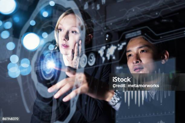 Two Persons Looking At Graphical User Interface Futuristic Business Concept Stock Photo - Download Image Now