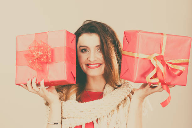istock Woman holds red christmas gift boxes 861154364
