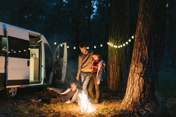 istock Friends  near the campfire in forest 861154374