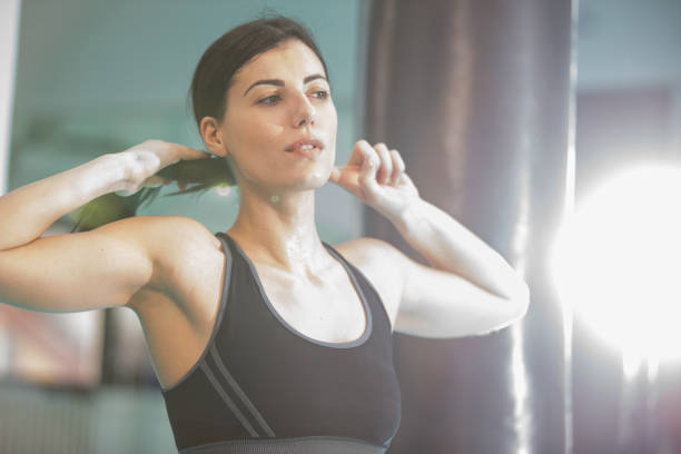 istock Woman tying ponytil in gym 861162338
