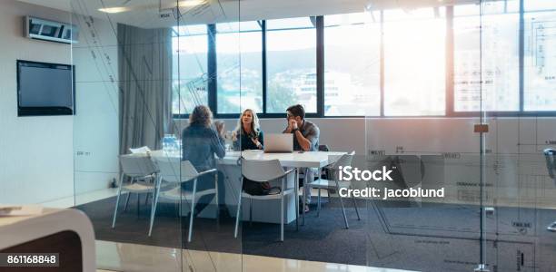 Three Designers Discussing In Meeting Hall Stock Photo - Download Image Now - Meeting, Customer, Office