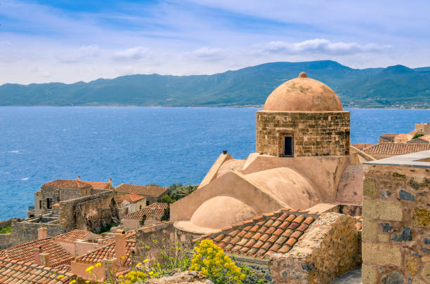 old church inside the castle of Monemvasia overlooking the endless blue of aegean sea at sunset time. old church inside the castle of Monemvasia overlooking the endless blue of aegean sea at sunset time. monemvasia stock pictures, royalty-free photos & images