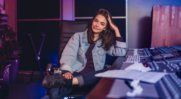 istock Female music composer sitting by sound mixing console 861172988
